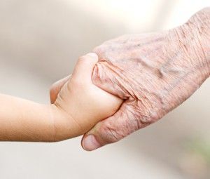 An old woman and a kid holding hands together