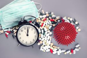 Coronavirus, face mask and drugs on grey background. Top view