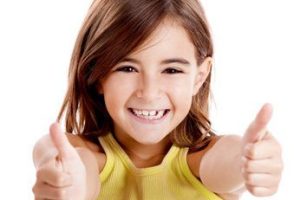 Portrait of a beautiful and confident girl showing thumbs up isolated one white