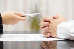 man refusing to sign a document