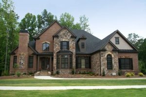 Upper class luxury home with intricate stonework and brick