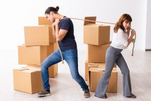 Young pair and many boxes in the divorce settlement concept