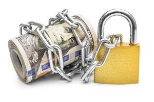 Dollar bills wrapped by chain and secured with padlock. Isolated on white. Safety money and investment concept.